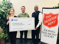 Dominion Energy and The Salvation Army holding grant check.